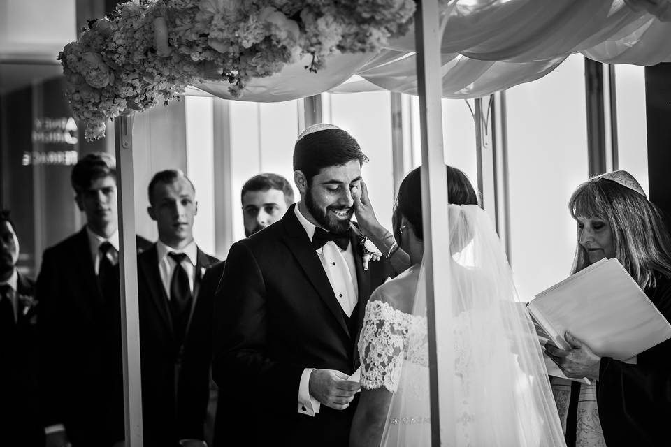 Bride wiping grooms tear