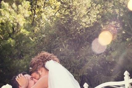 Groom spinning with his bride in his arms.