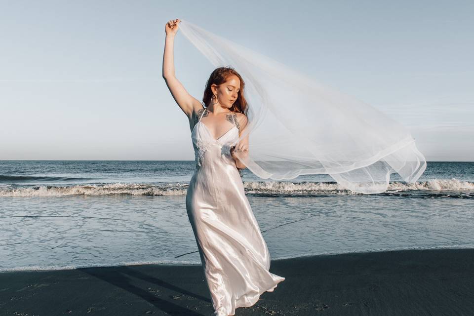 Bride with veil on beach