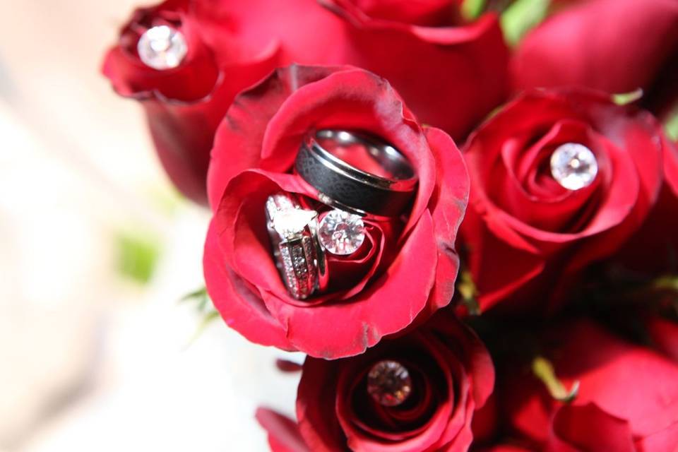 Wedding rings on top of roses