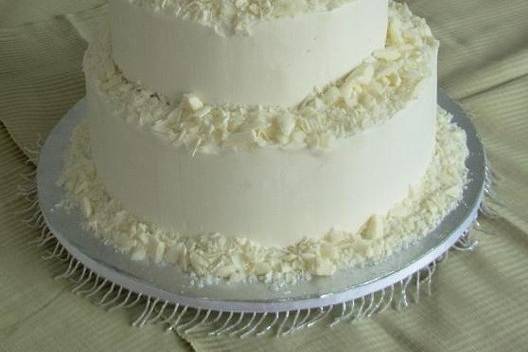 White Chocolate Shavings surround this simple white cake for a winter wedding.