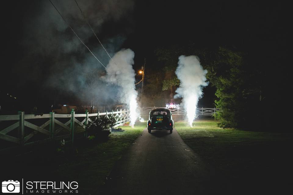 Elegant exit is included with our weddings as the vintage car leaves amid fireworks