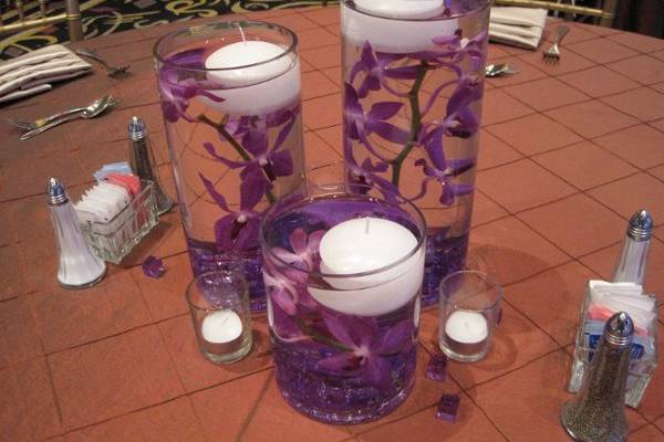 Multiple vases with Mokara Orchids and Floating Candles