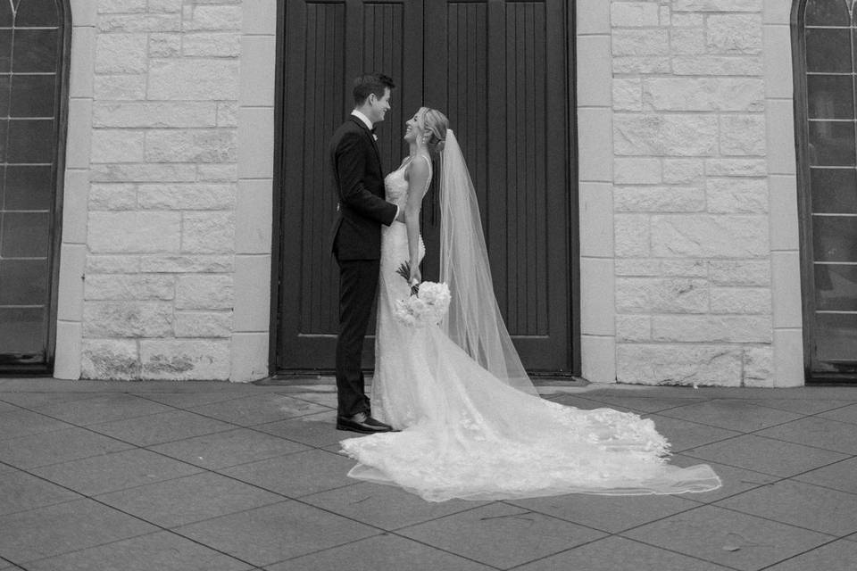 Bride and groom by chapel