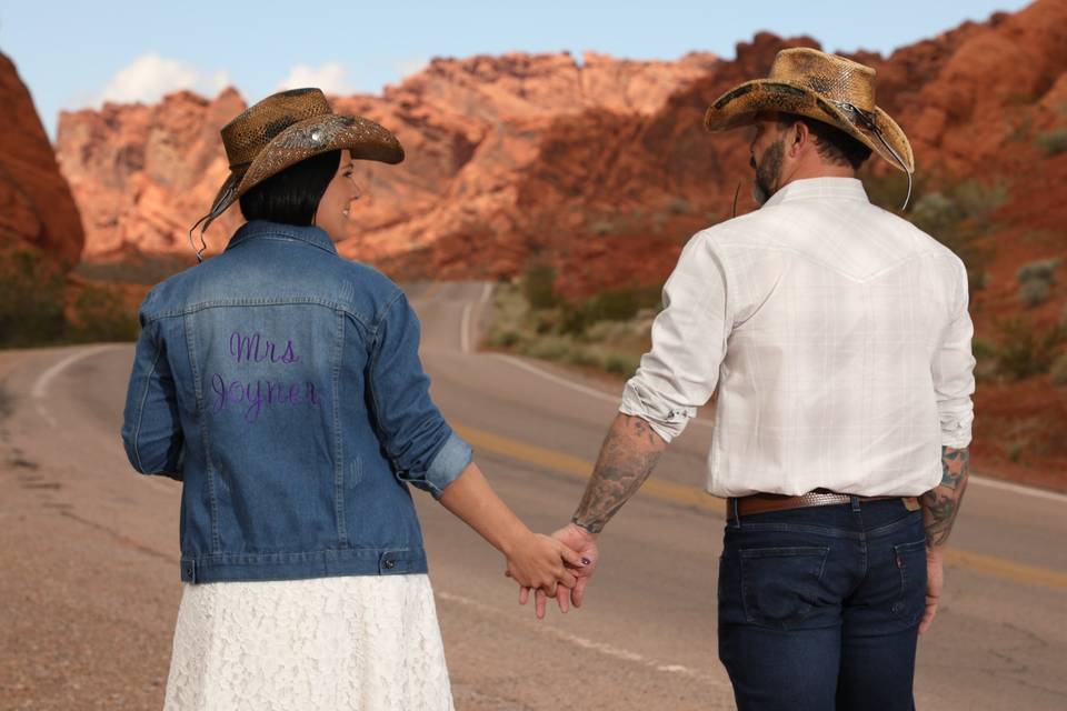 Couple holding hands on road