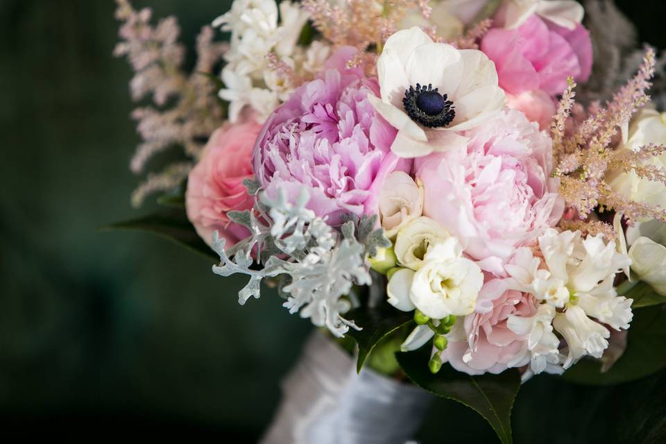 Romantic bouquet with peonies, dusty miller, freesia and other spring blooms