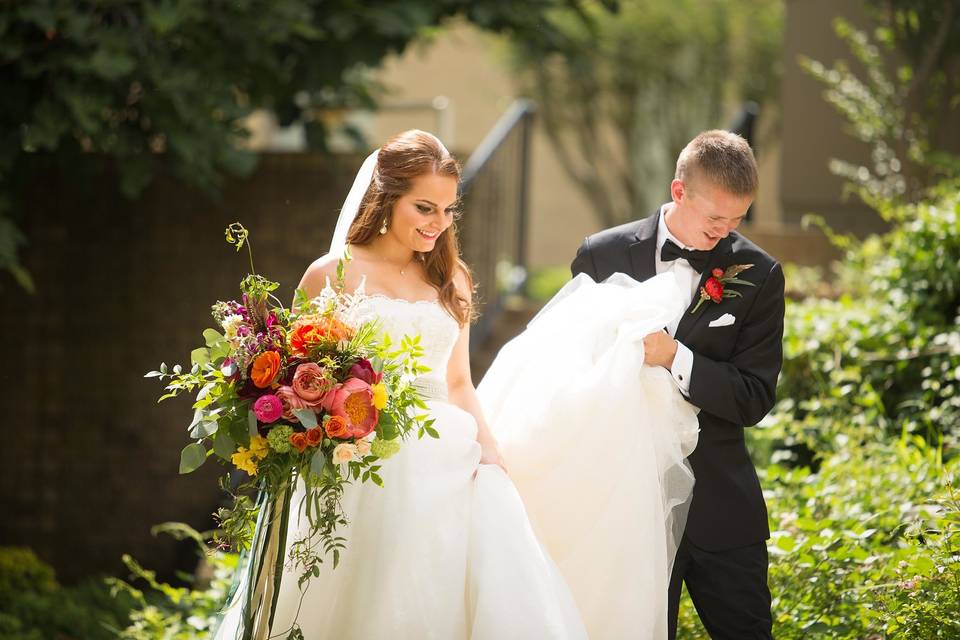 Newlyweds beginning their story by navigation of the stairs in the church grounds