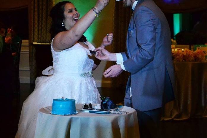 Newlywed couple eating wedding cake