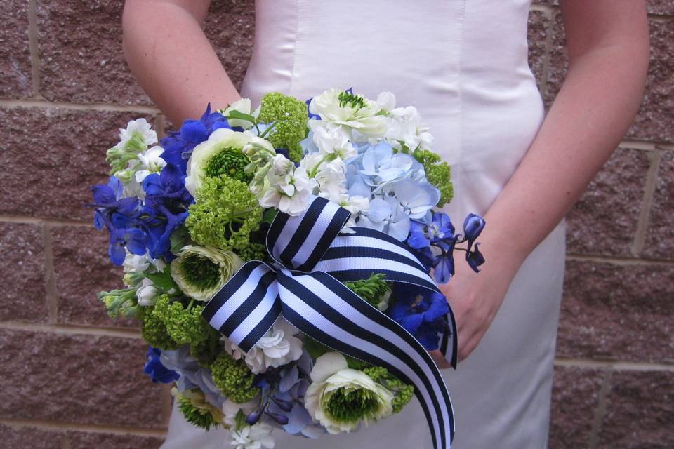 Green, blue, and white bouquet with ribbon
