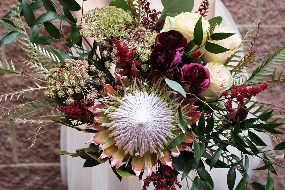 Protea and burgundy bouquet