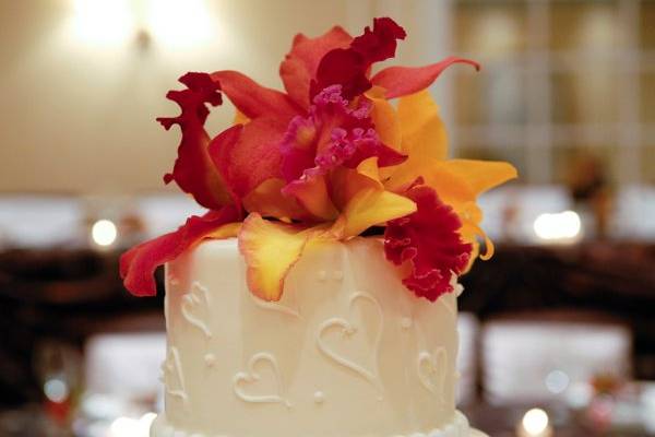 Rare novelty cattleya orchids in fall colors adorned the wedding cake