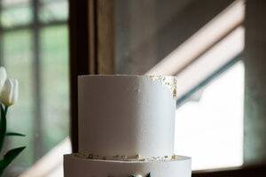 Wedding cake with gold leaf.
