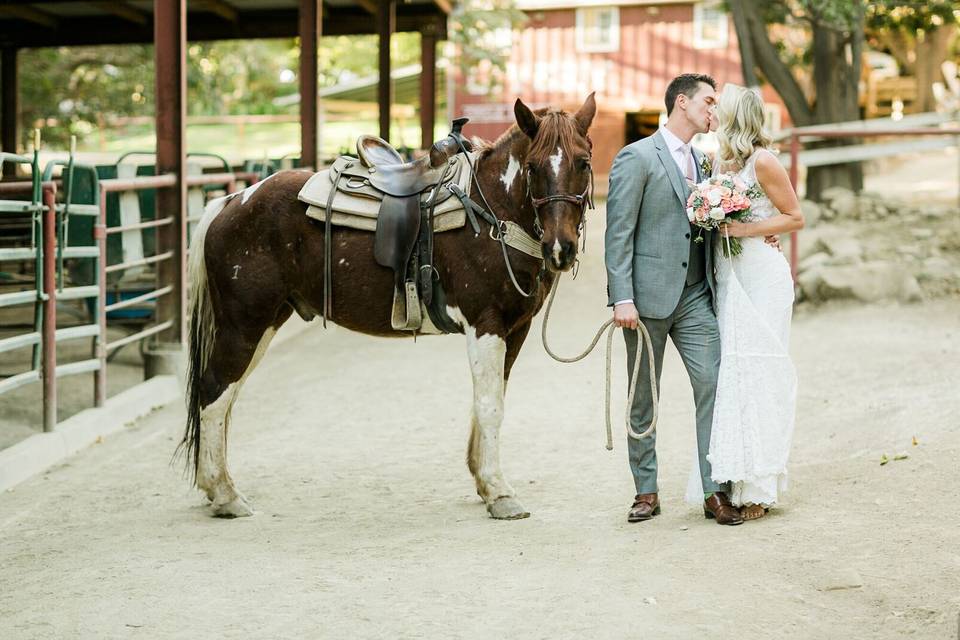 Happy couple with one of the ranch horses at the Circle Bar B Stables