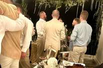 Groomsmen enjoying a cigar