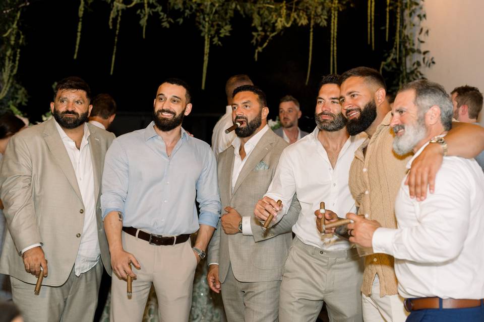 Groomsmen enjoying cigars