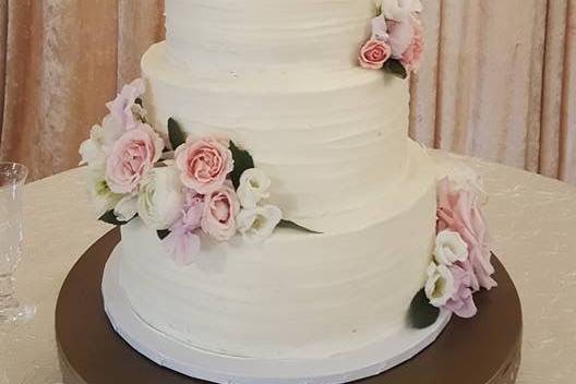 White cake with pink and white flower decor