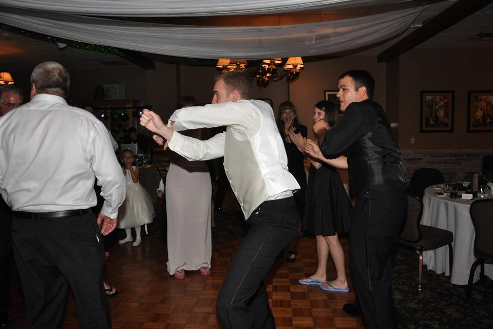 The groom dancing with guests