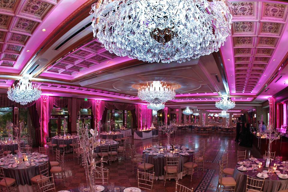 Opulent chandeliers and pink uplighting