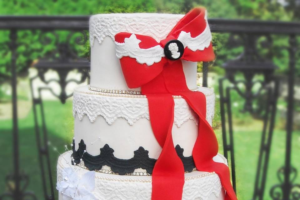 Tall wedding cake with red bow