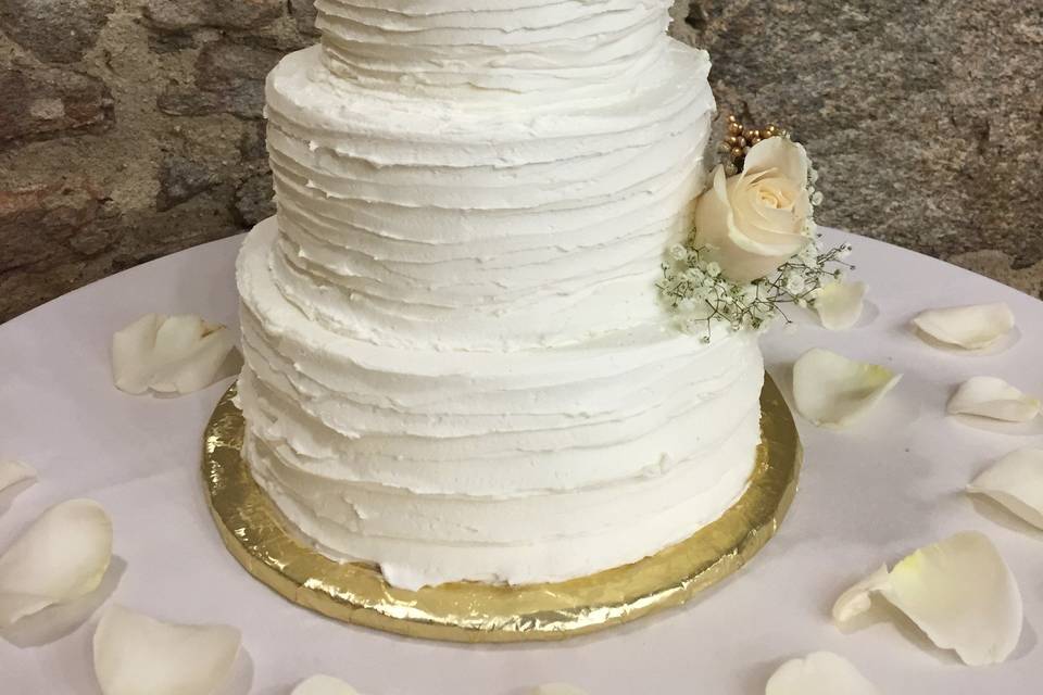 All white wedding cake with roses