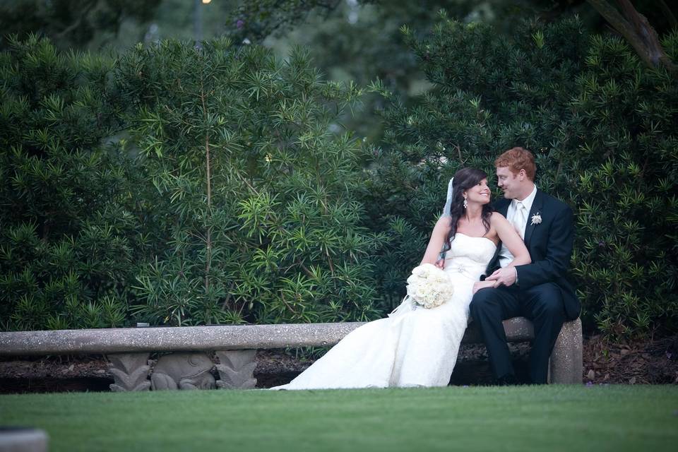 Bride and groom relaxing on bench in the beautiful Botanical Garden at City PArk, NOLA