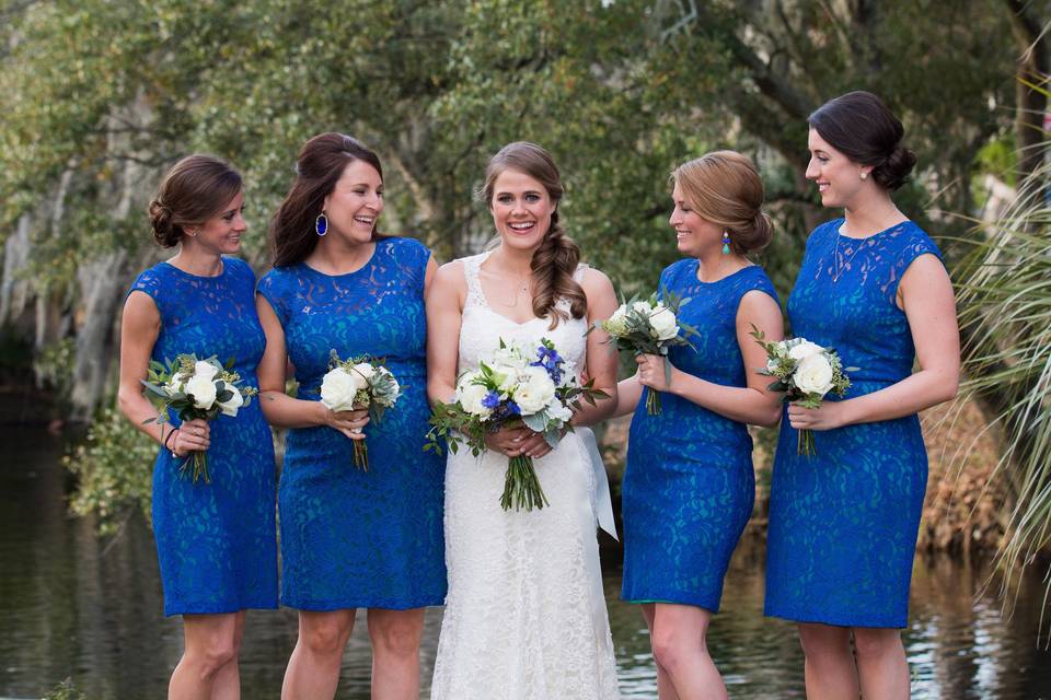 The bride with her bridesmaids holding a bouquet