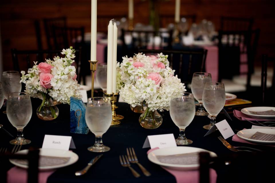Black reception table with pink decor