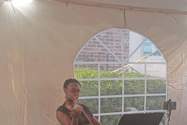 Playing violin under a Tent
