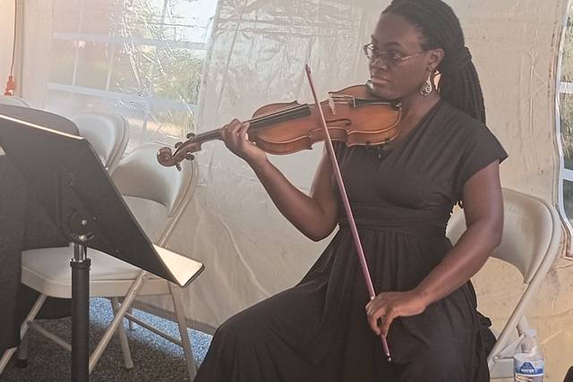 Playing Violin Under a Tent