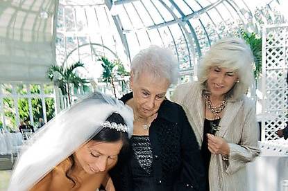 Brooklyn Botanical Ggarden, New York. Jewish wedding. Bride signing a Jewish document in reception area.