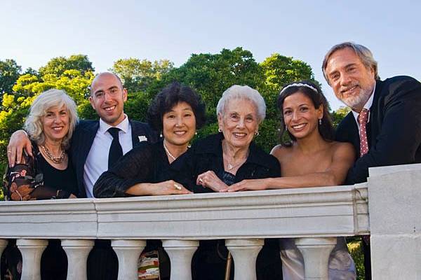 Brooklyn Botanical Garden, New York. Jewish wedding. Bride and groom with groom's family.