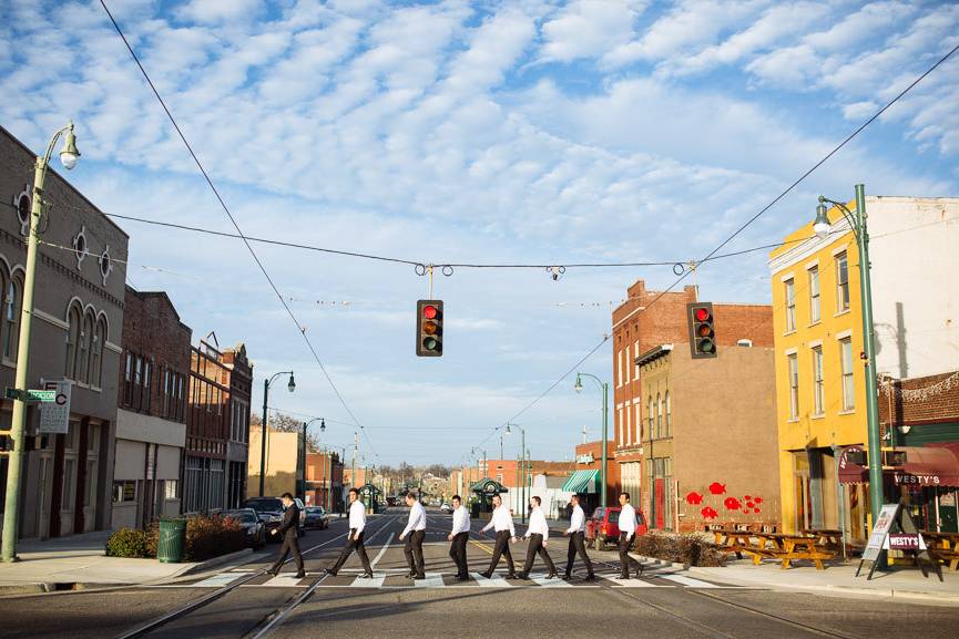 Groom crossing the street with his groomsmen