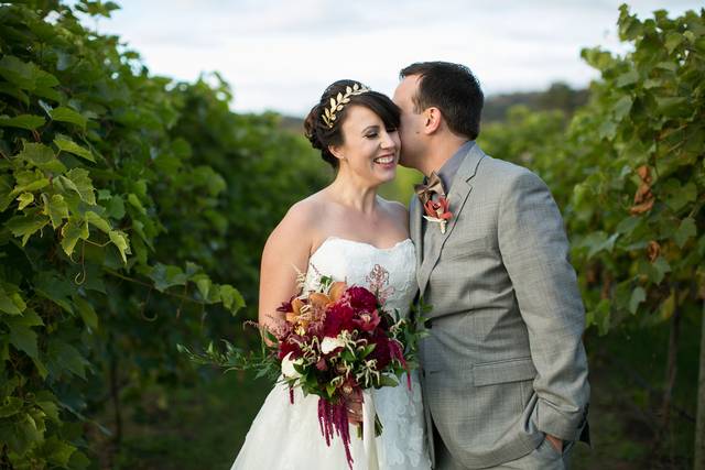 Groom kisses his bride in the field