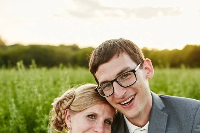 Bride and groom lying on the field