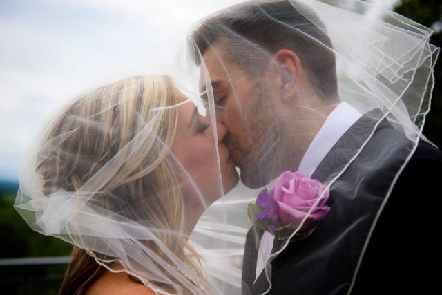 Newlyweds kissing under the veil