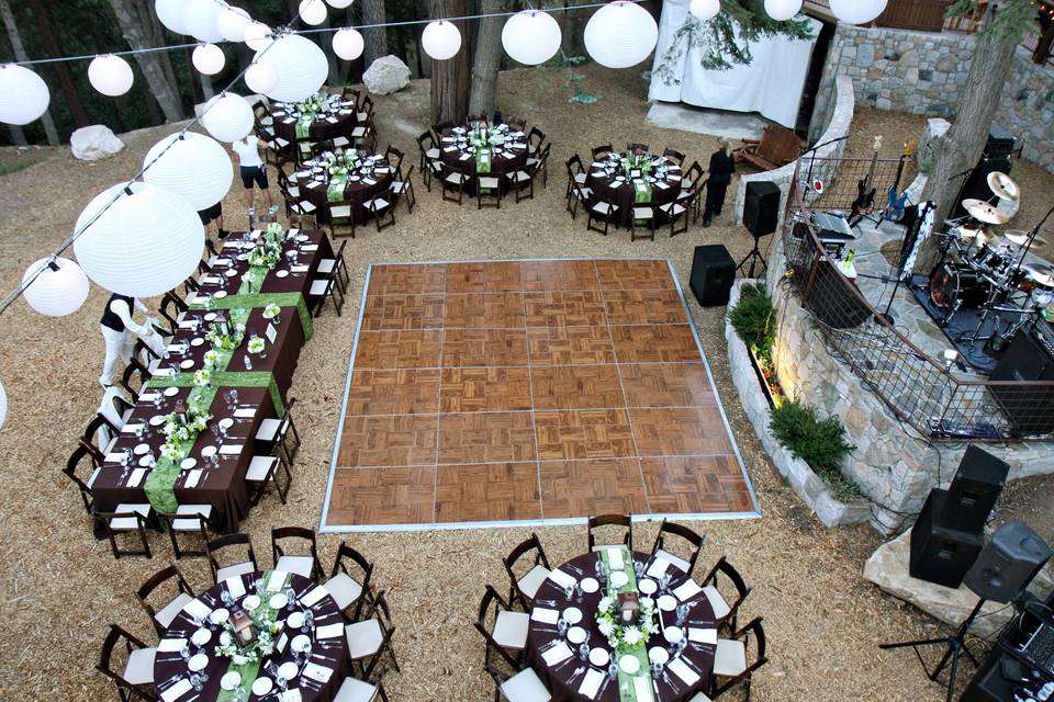 Dance floor & tables surround the floor with accents of lighting. Notice the stage for the live band in the rock terrace