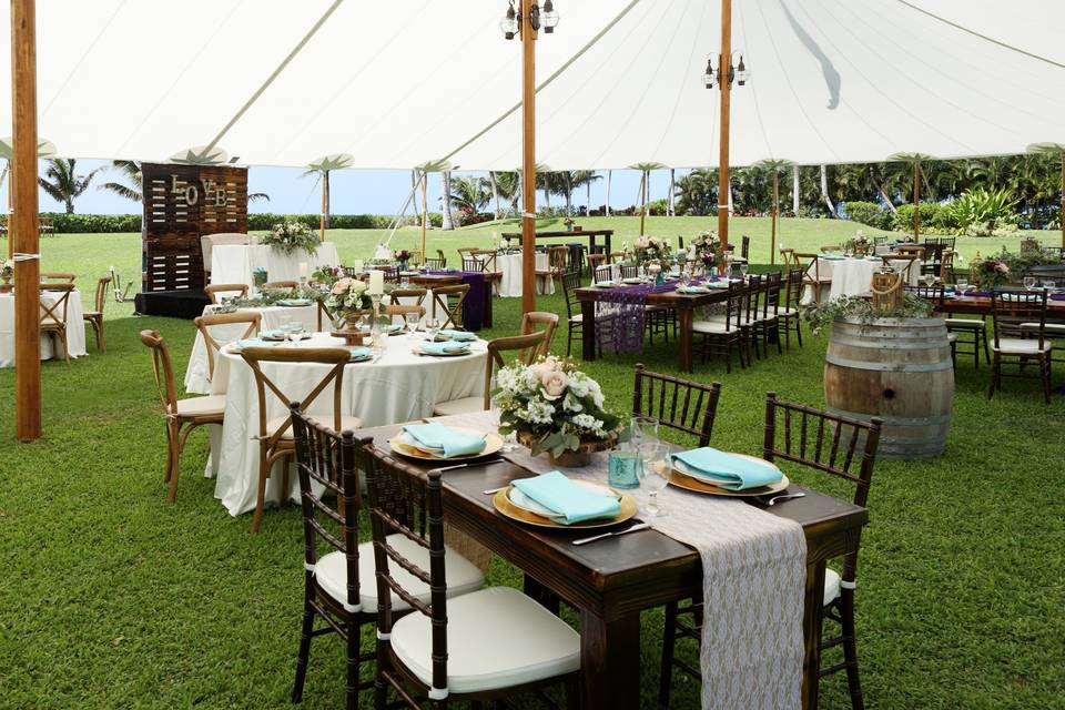 Under the light and beautiful sailcloth | Lovely rustic farm tables, crossback chairs, pallet wall design by Hawaii Tents & Events and linens-décor too!
