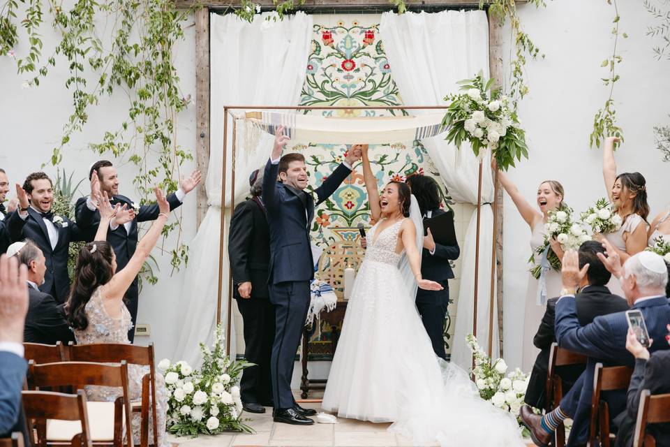 Copper chuppah and happy coupl