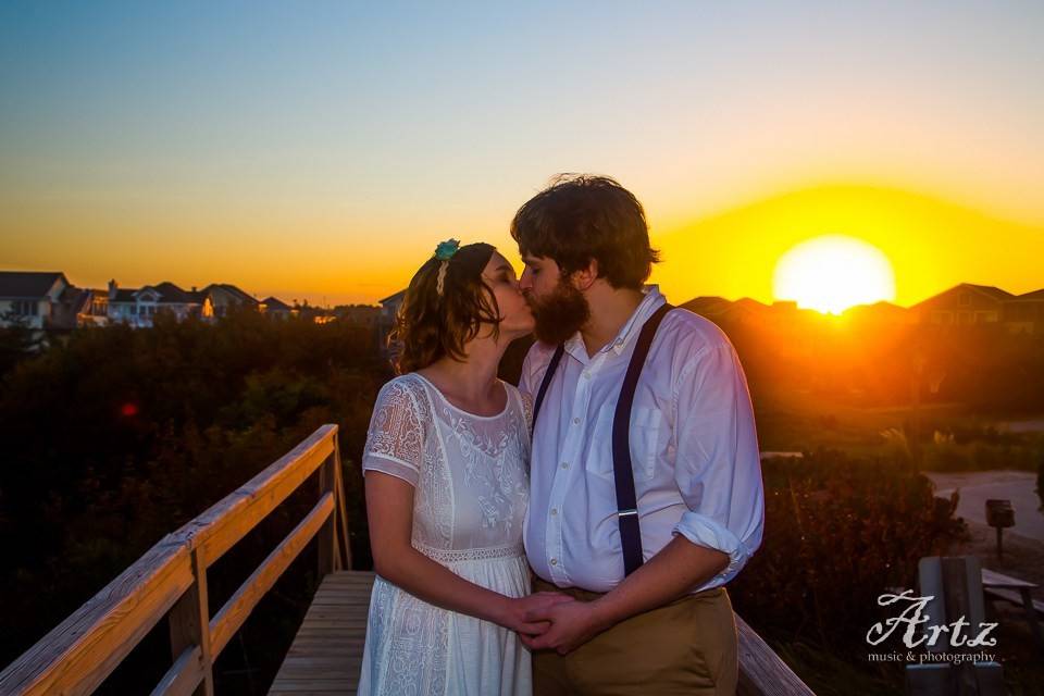 Couple kiss by the sunset