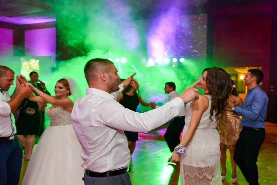 Newlyweds and guests dancing