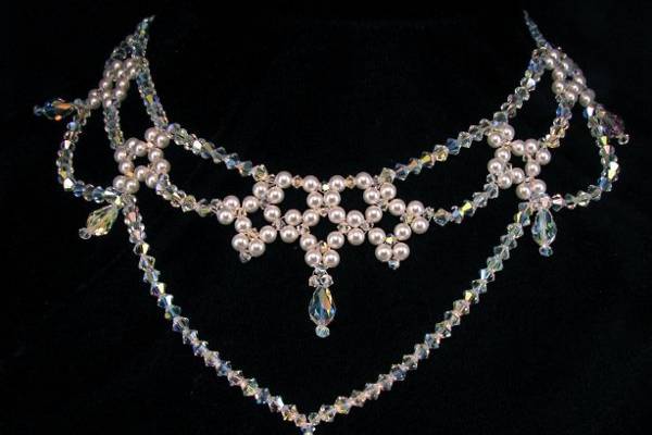 The Nicole Bridal Choker created with Swarovski crystals and pearls. https://twobewedjewelry.com/product/pearl-statement-necklace-bridal-choker-drape-necklace-sbj-nico/