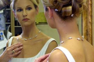 Bride gazing into mirror