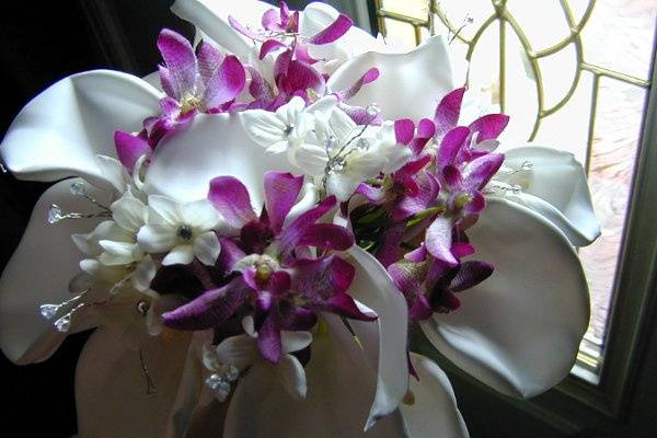 White Calla Lilies, Purple Orchids, Stephanotis with Rhinestone center. Added Aurora Borealis wired beads.
