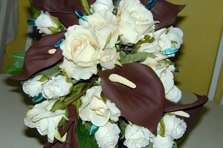 Chocolate Calla Lilies with hand wired turqouise glass diamond shaped beads. With cream colored roses.