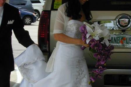 Brides Bouquet made up of Asian White Lilies and Purple Orchids in an extended cascade.