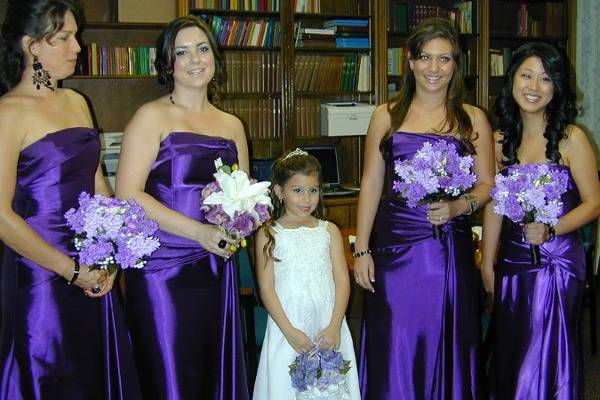 Bridal Party, mostly in Lilacs except for the Maid of Honor who had a compllimenting White Asian Lily with Purple roses just like the brides but in a different design.