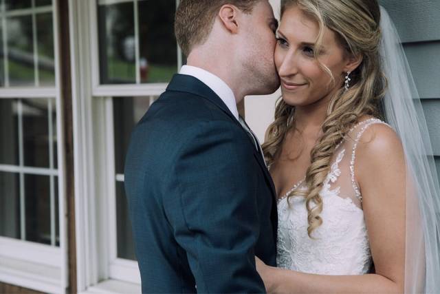Groom kissing his lovely bride