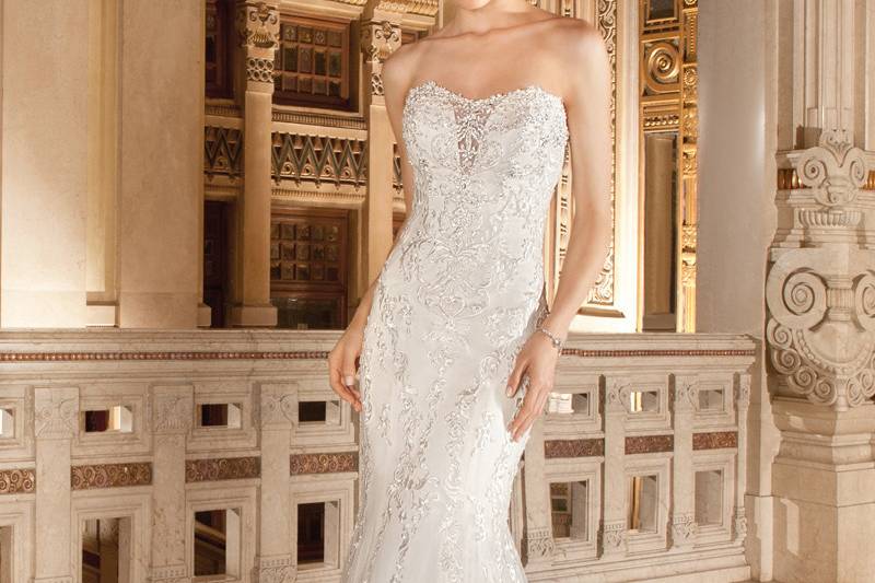 1481This sultry strapless, form -fitting gown with soft sweetheart neckline and illusion insert is adorned with embroidered lace and accents of delicate beading on the bodice. The back features a lace-up closure and sweep train.