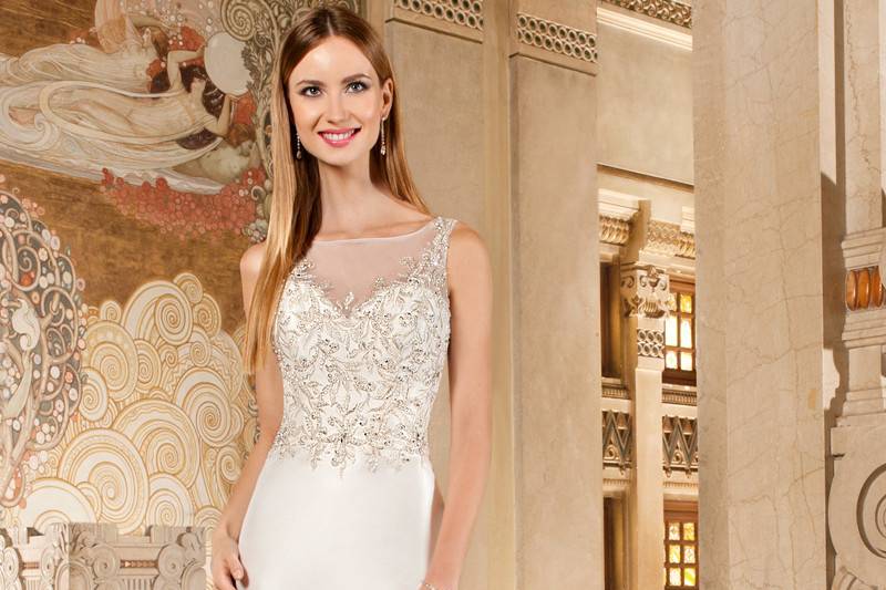 3213Chic, sleeveless, mikado, form fitting gown features a magnificent sheer beaded bodice over a sweetheart neckline and sheer beaded low v-back with button closure. Back is finished with chapel train.