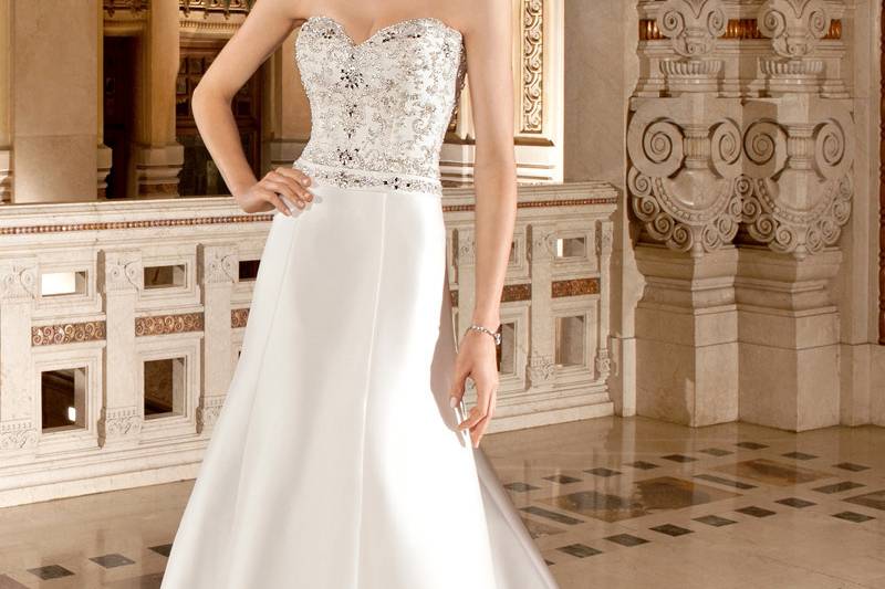 3215This elegant, mikado, strapless, modified a-line gown with a sweetheart neckline features beaded embroidery with clusters of jeweling on the bodice and  beaded trim on the natural waist. The back features a button closure with buttons cascading down entire skirt into chapel train.
